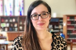 Roxana Banu, who has long dark brown hair and glasses