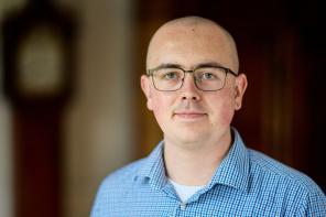 Samuel Johnson, a man wearing glasses and a blue shirt