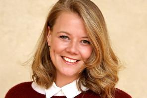 Photo of Dr Melanie Sauter, who has long light brown hair and is wearing a red top