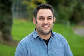 Prof Aziz Aboobaker, who has short dark hair and is wearing a blue shirt