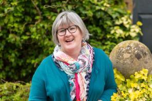 Portrair of smiling professor Dr Anne Mullen in LMH gardens, picture taken by Dominik Osvald, May 2019