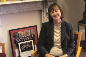 Margaret Coombe sitting on a chair in her office