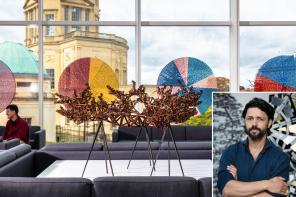 Sculpture by Conrad Shawcross on display in Oxford’s Mathematical Institute, featuring a complex bronze geometric structure and colourful circular artworks in the background. An inset shows a portrait of Shawcross with arms folded, standing in front of another sculptural work.