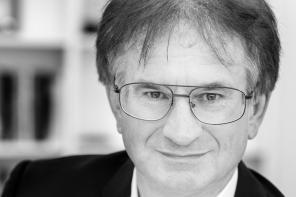 Black and white close-up of Professor Todd Huffman, who has short dark hair and wire-framed glasses