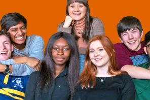 A group of seven LMH students huddled together on a sofa having fun