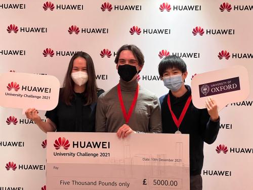 Jiazheng Zhu, Natalia Hong and Munib Mesinovic receiving a giant check for £5,000 at the annual Huawei Hackathon