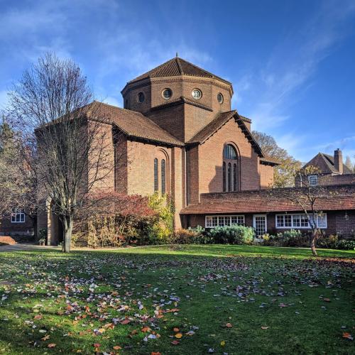 View of the LMH Chapel from outside. Leaves cover the grass outside in this autumnal photo.