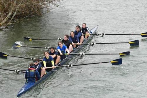 A rowing boat with crew on the river