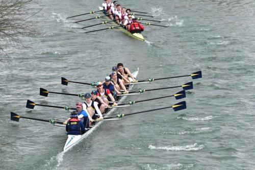 Two rowing boats and crews on the river