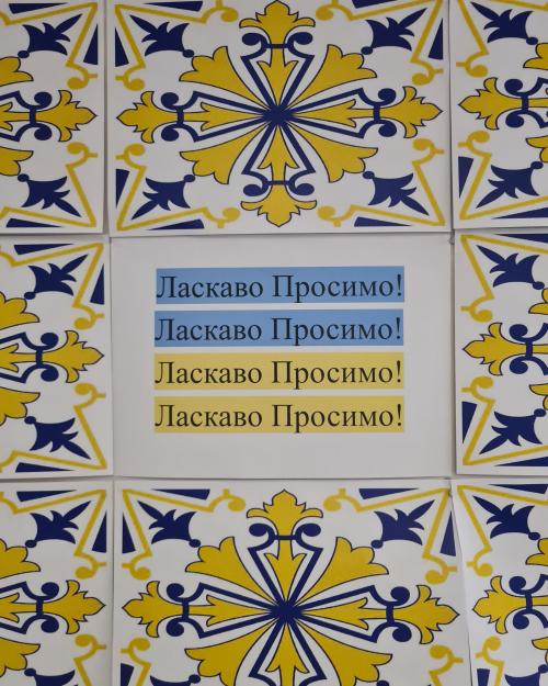 Posters with blue and yellow patterns and a central poster with words in Ukrainian