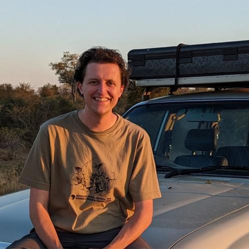 Tom Pavey sits on the bonnet of a van