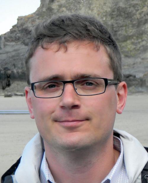 Headshot of Professor Jose Goicoechea, wearing glasses and smiling at camera