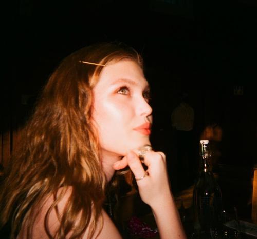 Side profile of Martha, smiling as she stares into the distance