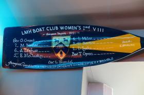 Close up of the blade of a rowing oar with hand painted text