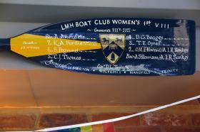 Close up of the blade of a rowing oar with hand painted text