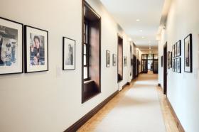 A view down the corridor, portraits on each side