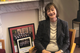 Margaret Coombe sitting on a chair in her office