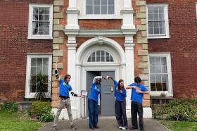 LMH student ambassadors standing outside Bruce Castle Museum, using their bodies to spell ‘LMH