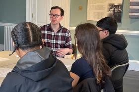 LMH academic leading a small group discussion with Year 12 students during a supercurricular session at Bruce Castle Museum.