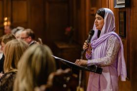 Malala giving a speech at her portrait unveiling