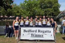 LMH Women's team stood with the Bedford Regatta trophy in front of the river