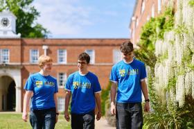 Three students wearing blue LMH T shirts
