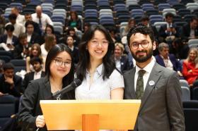 Sum Lau, Yvette Young, and Syed Adil in front of a lectern