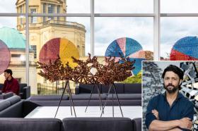 Sculpture by Conrad Shawcross on display in Oxford’s Mathematical Institute, featuring a complex bronze geometric structure and colourful circular artworks in the background. An inset shows a portrait of Shawcross with arms folded, standing in front of another sculptural work.