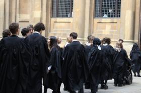 A group of students wearing black degree robes lining up to go into their degree ceremony.