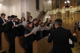 A group of student choir members performing in the LMH chapel