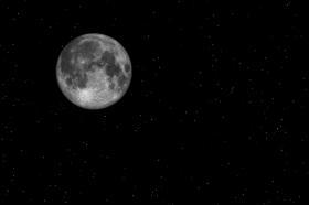 A photo of a full moon in a starry night sky