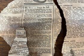 A ripped and discoloured newspaper clipping