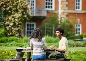 Two students studying in the garden