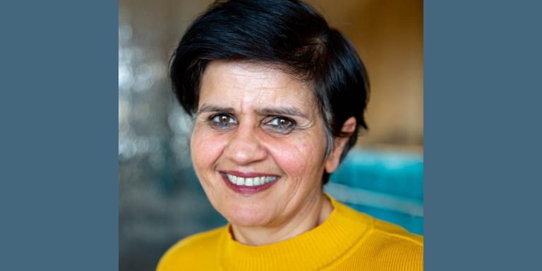 Prof Monima Chadha, who has short dark hair and is wearing a yellow top