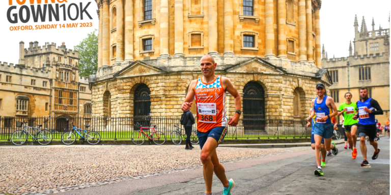 A runner wearing blue and orange passes the Radcliffe Camera