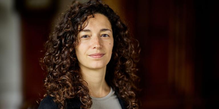 Silvia Butti, who has long dark brown curly hair