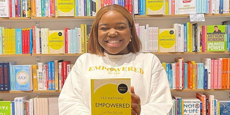 LMH alumna Vee Kativhu holding her book Empowered