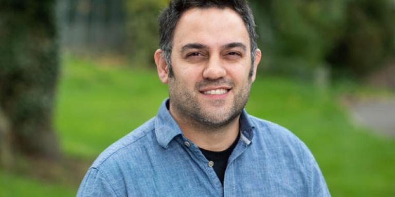 Prof Aziz Aboobaker, who has short dark hair and is wearing a blue shirt