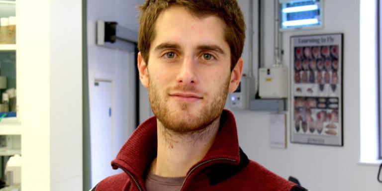 Rui Ponte Costa, who has short dark brown hair and a beard, wearing a red jumper
