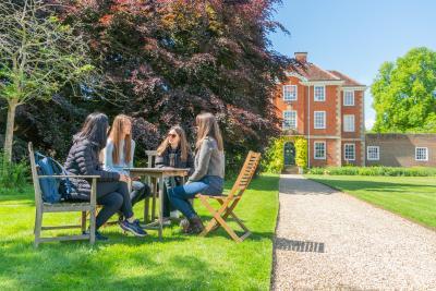 LMH students sitting at a table chatting in LMH grounds