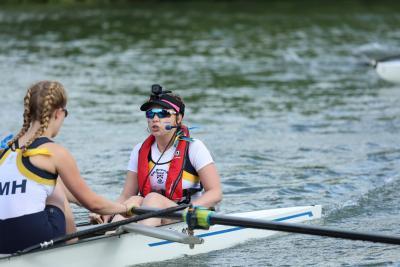 Eve as a cox on a rowboat