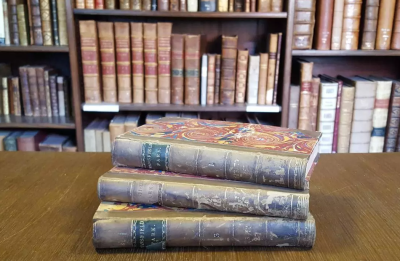 A view of the first edition of Mansfield Park (1814) in 3 vols., placed on a table in LMH Library
