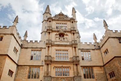Looking upwards at a sandstone tower at the Bodleian Library.