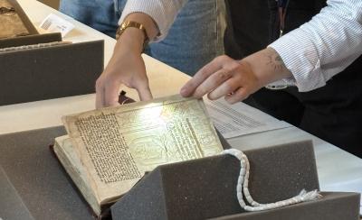 A Bodleian curator presents a rare book to an LMH student