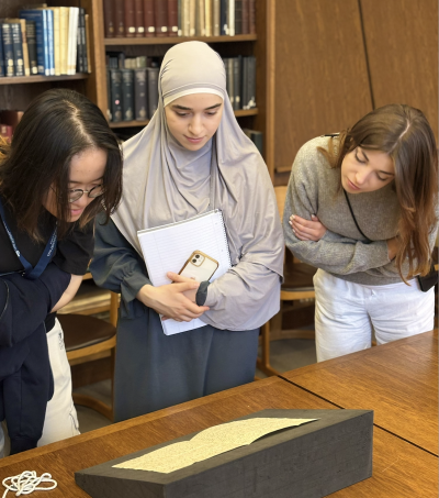 Three LMH students looking at Jane Austen's handwritten letters in the Bodleian Library