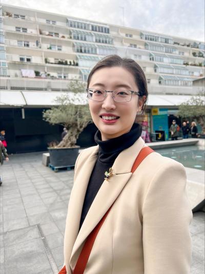 Picture of Nora standing in front of buildings
