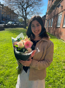 Agnes with a bouquet of flowers
