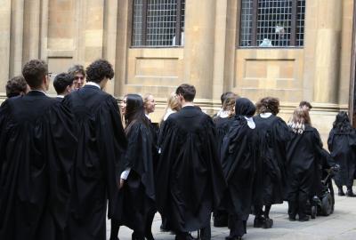A group of students wearing black degree robes lining up to go into their degree ceremony.
