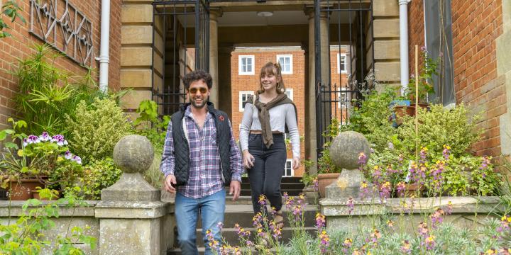 Two students walking through an archway at LMH