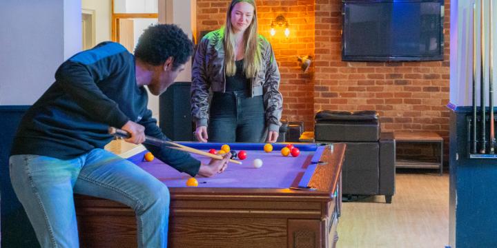 Two students playing pool in the LMH Bar